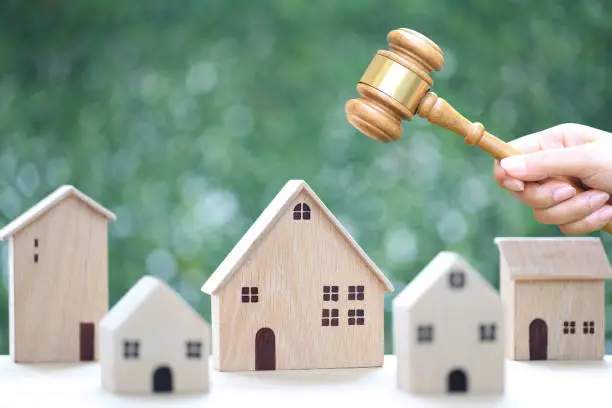 Wooden houses and gavel representing probate law and real estate transactions in Texas.