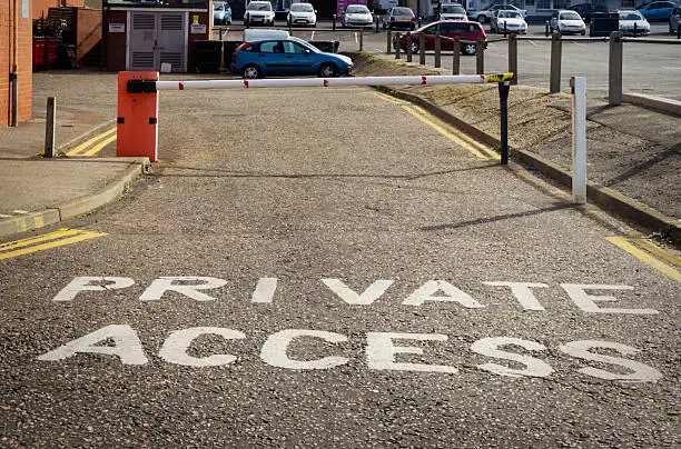 Private access gate with signage indicating restricted entry, relevant to probate real estate management and property access issues in Texas.