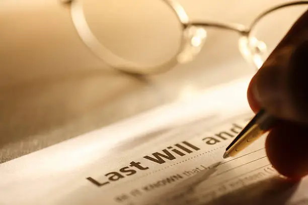 when it comes to navigating the labyrinth of probate law, texas stands as both a haven and a maze, man signing last will and testament