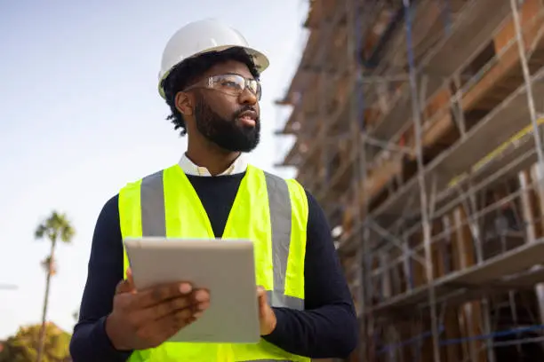 managing probate property in texas involves a wide range of responsibilities for heirs and estate executors, young black male project manage with safety vest and helmet