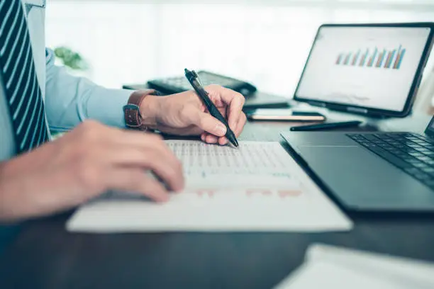 the digital revolution has drastically reshaped how people store and manage their wealth, businessman working on office desk and analyzing new project of accounting finance investment