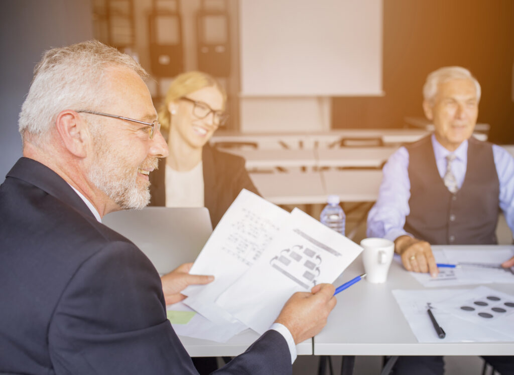 blended families are becoming increasingly common, senior businessman discussing paper with his colleague office