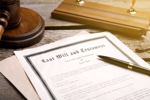 in, last will and testament pen and gavel on wooden table closeup