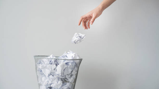 in, woman hand throwing crumpled paper in basket