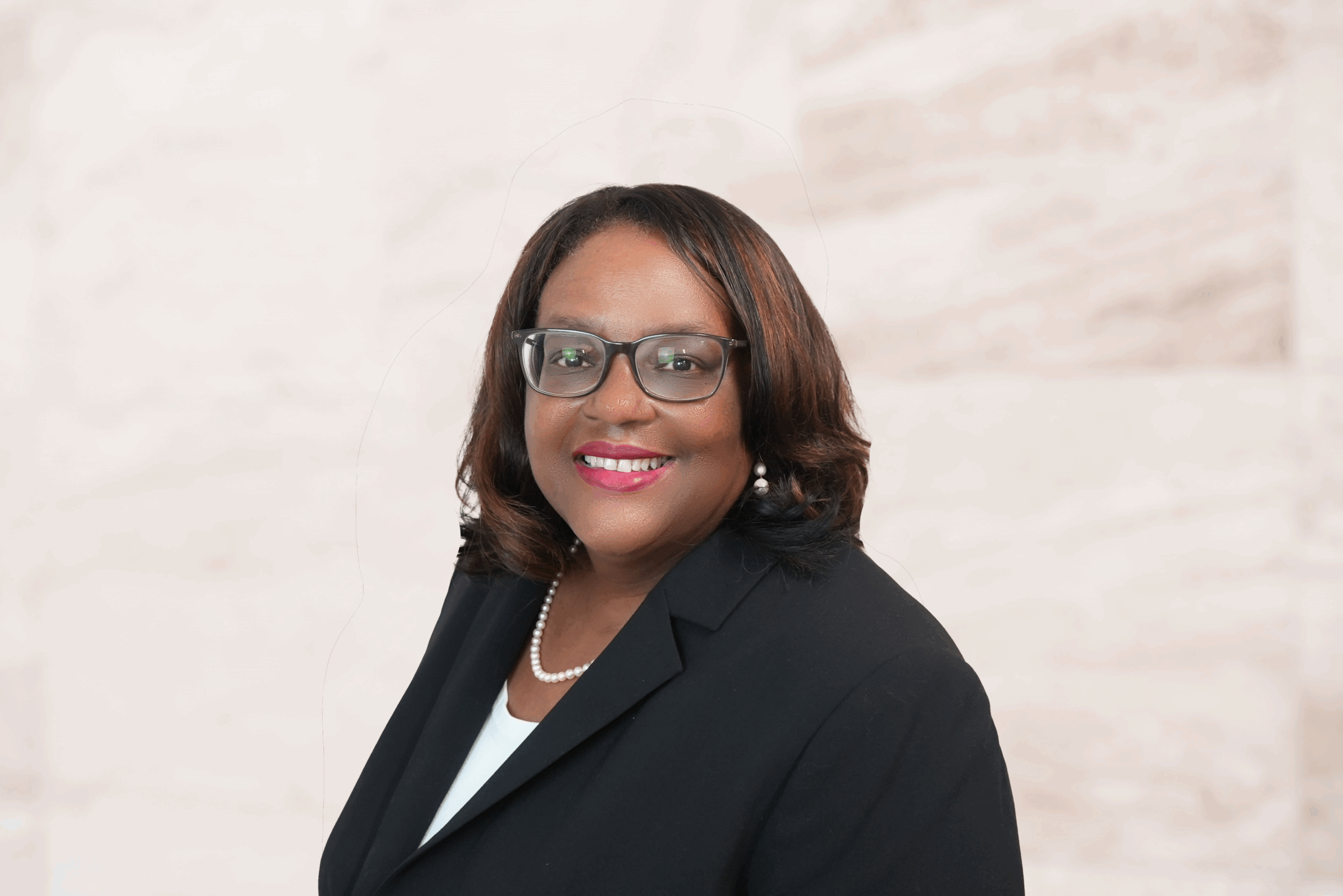 Glenda C. Clausell, Supervising Estate Planning, Probate, and Guardianship Attorney at Bryan Fagan Law Office, smiling in professional attire with a pearl necklace, against a neutral background.