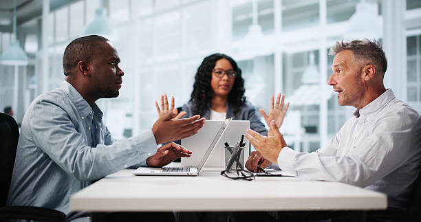 Legal mediation session with two individuals discussing heatedly across a table, while a third person observes, emphasizing conflict resolution in co-heir property disputes.